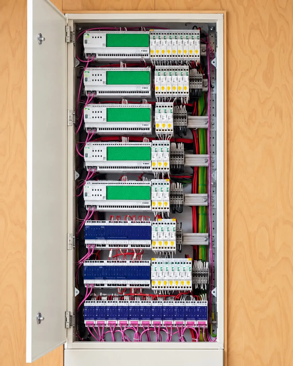Smart-home control modules and circuit protection, neatly wired in a joinery-housed cabinet